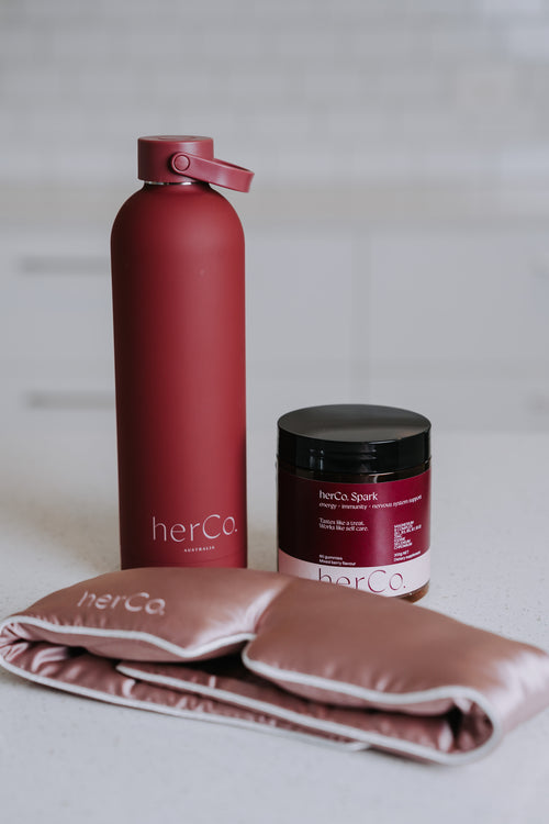 herCo. water bottle, 100% silk eye mask, herCo. Spark gummies (energy + immunity + nervous system support)