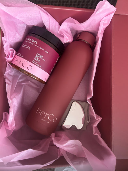 herCo spark gummies, with a dark matte herco waterbootle and luxe gua sha 